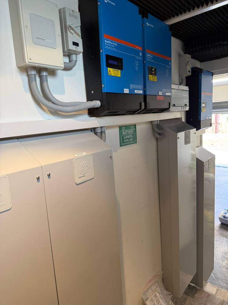 An 80 kWh installation of multiple battery cabinets with paired inverters in a garage