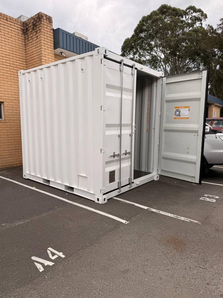 A new 10ft high-cube shipping container with doors open, being fitted out as a BPaaS Pod