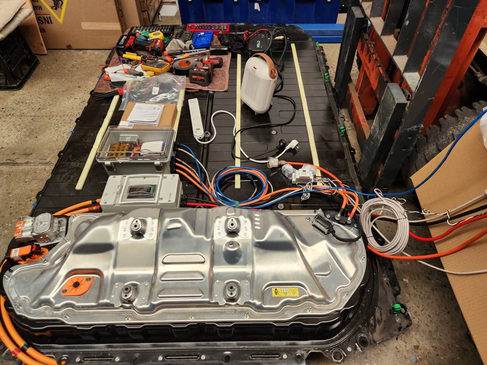 A full traction pack instrumented on a bench with test leads and monitoring equipment