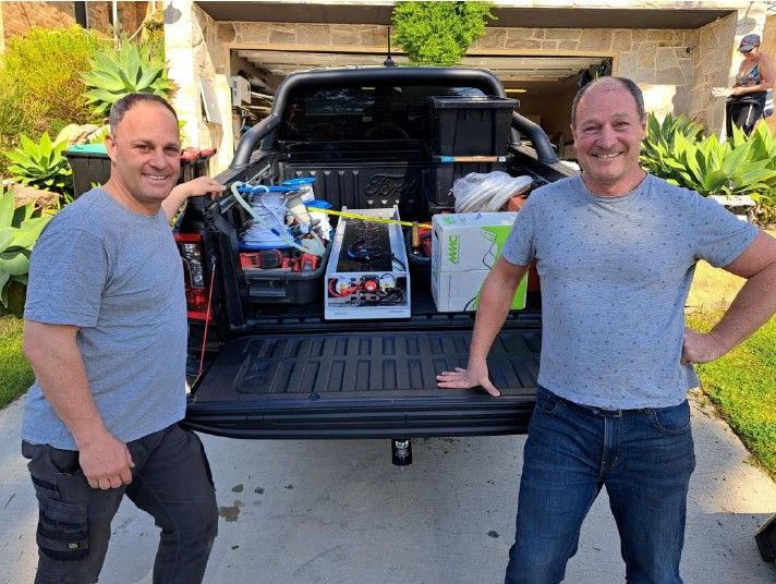 Steven and Mark Barnett beside a loaded ute, on the way to fit the first Upcycle Energy system